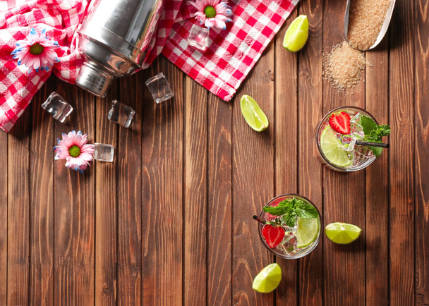 Glasses of fresh strawberry mojito on wooden table - Photo, Image
