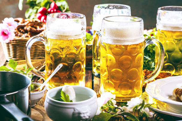 Oktoberfest beer, pretzels and various Bavarian specialties on wooden background - Fotografie, Obrázek