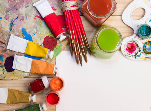 Paints, brushes  on the wood background. The workplace of the artist. Banner for school.  - Fotoğraf, Görsel