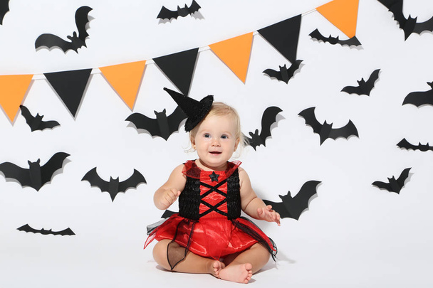Baby girl in halloween costume on white background - Foto, afbeelding