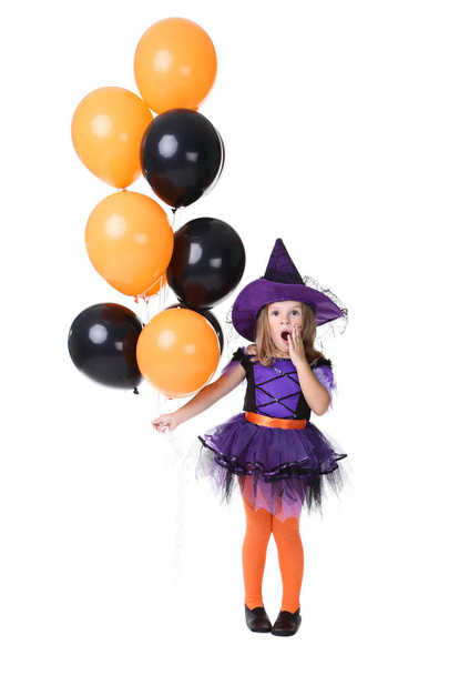 Young girl in halloween costume with balloons on white background - Fotó, kép