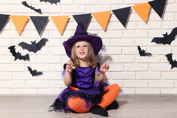 Young girl in halloween costume sitting on the floor - Foto, Imagem