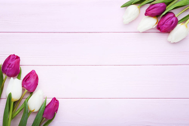 Bouquet of tulips on pink wooden table - Fotografie, Obrázek
