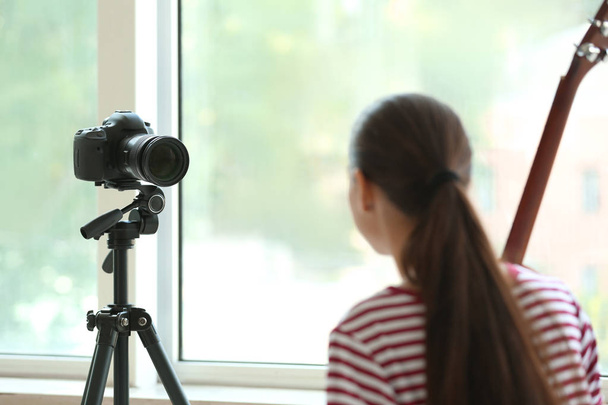 Young female musician recording video indoors - Foto, Bild