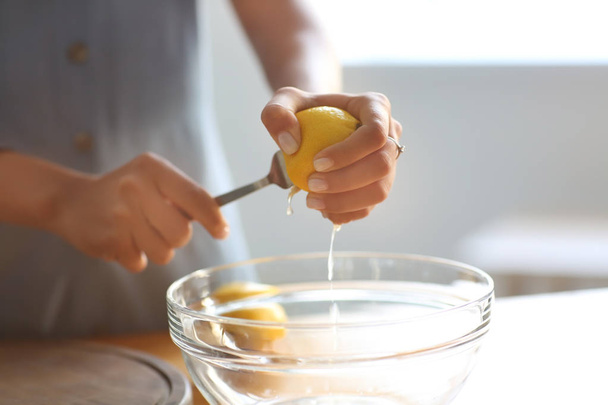 Young woman preparing fresh lemonade at home - Φωτογραφία, εικόνα
