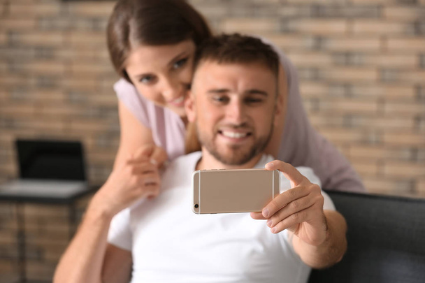 Happy loving couple taking selfie at home - Φωτογραφία, εικόνα