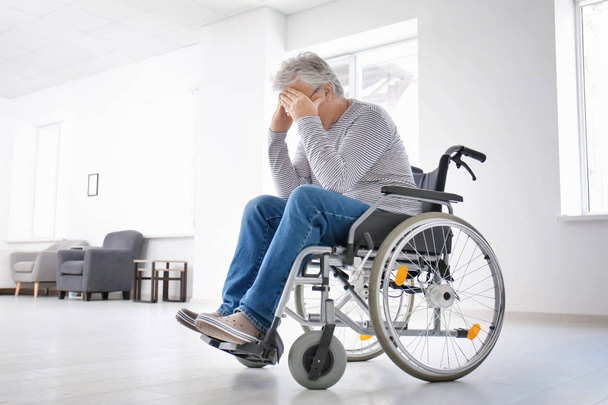 Depressed senior man in wheelchair at home - Fotó, kép