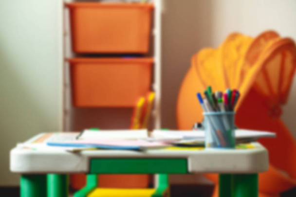 Blur background of children home work table at home. In afternoon in natural light. - Фото, изображение