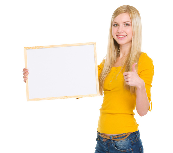 Happy student girl showing blank board - Fotoğraf, Görsel