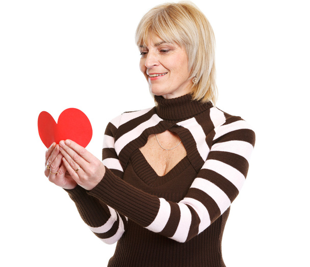Woman reading heart shaped postcard - Fotó, kép