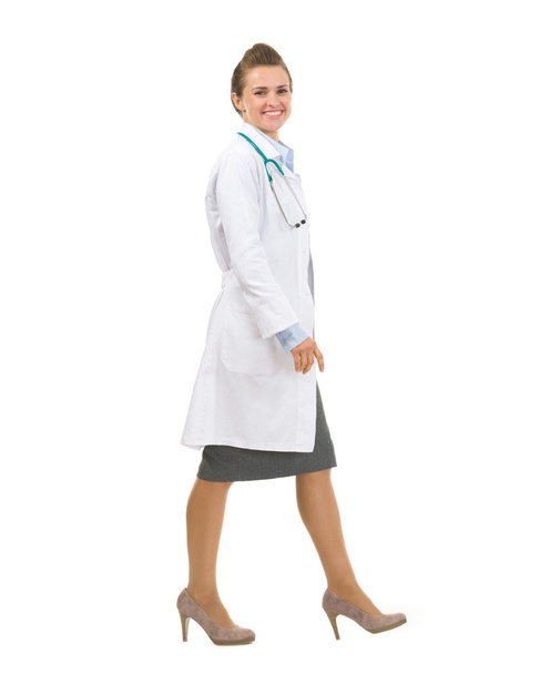 Full length portrait of medical doctor woman going sideways - Foto, imagen