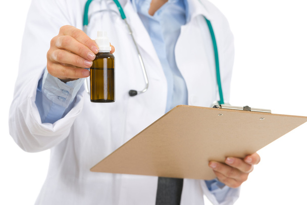 Medical doctor woman with clipboard and medecine bottle - Photo, image