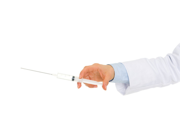 Closeup on hand of medical doctor holding syringe - Foto, afbeelding