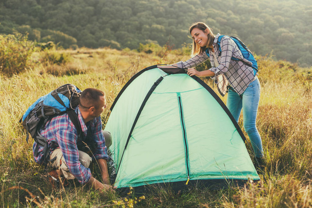 Happy couple is camping in mountain. - Valokuva, kuva