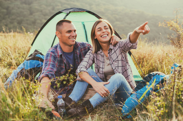 Happy couple is camping in mountain. - 写真・画像