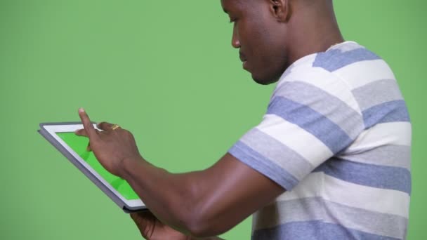 Young African man using digital tablet - Video