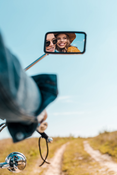 reflection of happy couple in rear view mirror of motorbike - Foto, Imagem