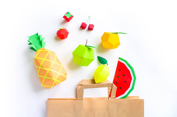 Paper bag of exotic fruits made of paper on white background. Shopping. Top view. Flat lay - Valokuva, kuva