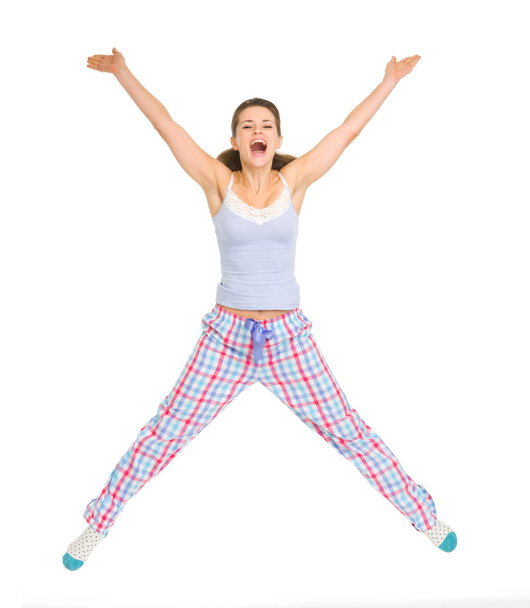 gülümseyen genç kadın pijama atlama - Fotoğraf, Görsel