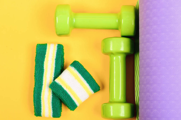 Barbells with white and green hand band. Sports and health - 写真・画像
