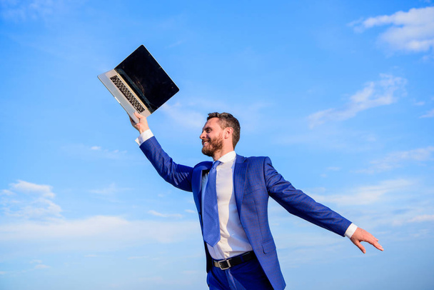 Businessman formal suit follow laptop. He has a dream. Businessman inspired entrepreneur feels powerful going to change world. Man inspired holds laptop above himself. Follow your interests - Foto, Imagen