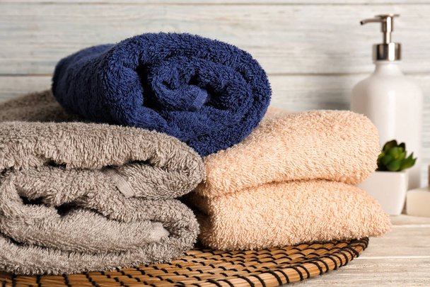 Different clean soft towels on light wooden table - Foto, Imagem