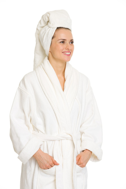 Happy young woman in bathrobe looking on copy space - Фото, изображение