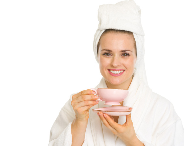 Young woman in bathrobe holding cup of coffee - Foto, Bild
