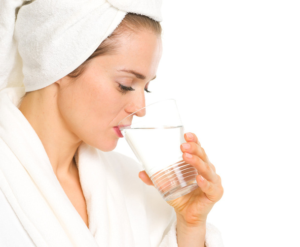 Young woman in bathrobe drinking pure water - Foto, Imagem