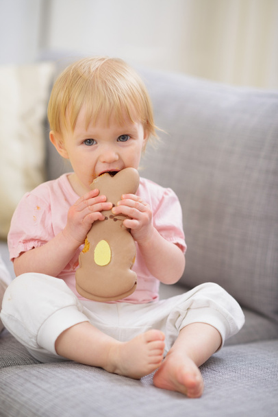 Baby eating Easter rabbit shaped cookie - Photo, Image