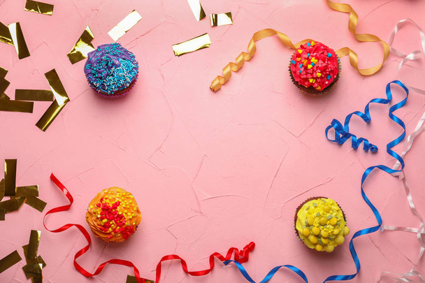 Delicious birthday cupcakes with serpentine and confetti on color background - Foto, immagini