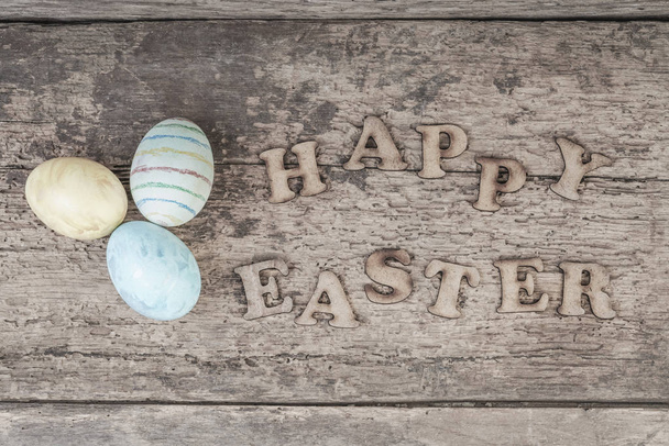 easter template with colorful eggs on wooden table with copy space - 写真・画像