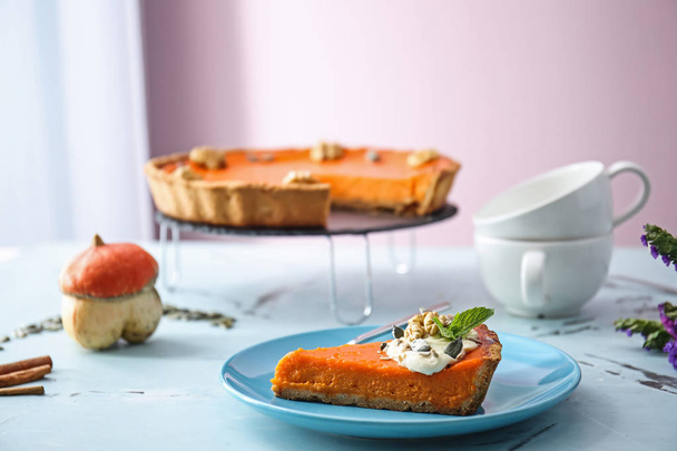 Plate with piece of tasty pumpkin pie on table - Photo, Image