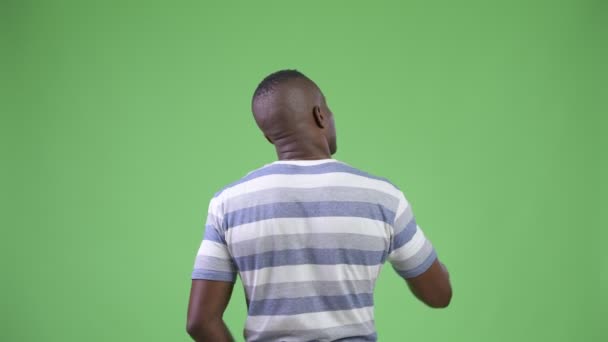 Rear view of young African man directing and pointing finger - Záběry, video