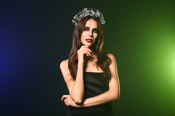 Beautiful woman dressed for Halloween on dark color background - Fotografie, Obrázek