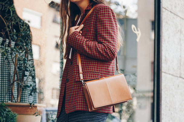 street style, attractive woman wearing a  mini skirt, check plaid blazer and a lether brown tote bag. fashion outfit perfect for autumn. style of 2018 autumn. - Fotografie, Obrázek