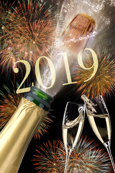  splashing bottle of champagne with flying cork and firework at Silvester 2019 - Fotografie, Obrázek