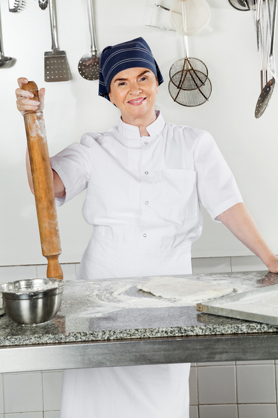 Female Chef With Rolling Pin By Kitchen Counter - Φωτογραφία, εικόνα