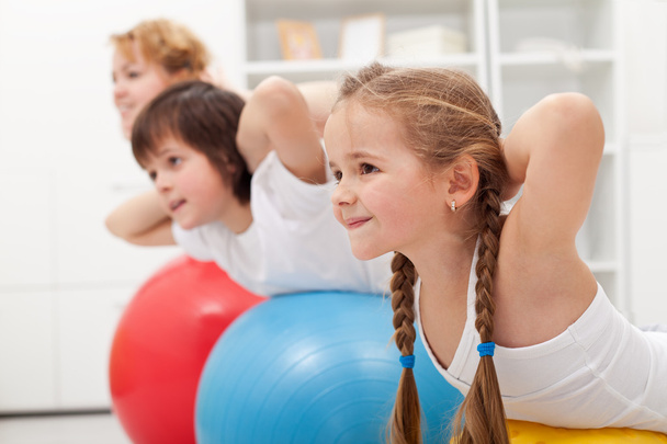 Kids and woman doing exercises with balls - Foto, Imagem