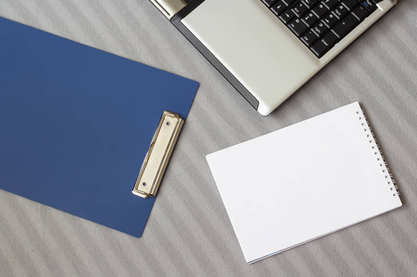 Laptop and notebook on a soft striped plaid - Fotoğraf, Görsel