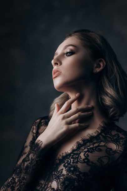 beautiful sexy young blonde woman posing in black lace lingerie - Fotó, kép