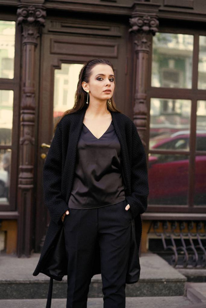 Gorgeous young brunette woman in black clothes posing  - Foto, Imagem