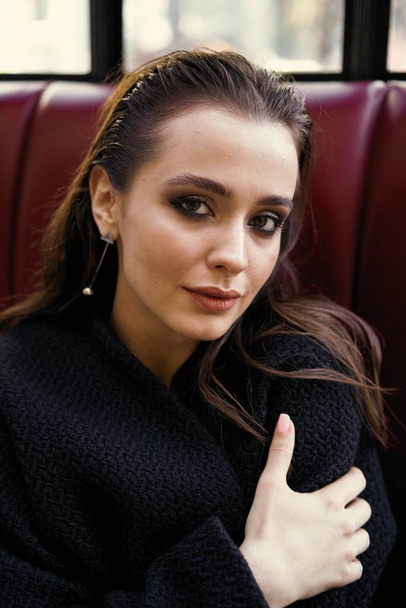 Gorgeous young brunette woman in black clothes posing - Fotó, kép
