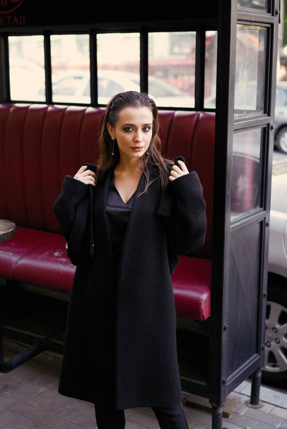 Gorgeous young brunette woman in black clothes posing - Fotó, kép