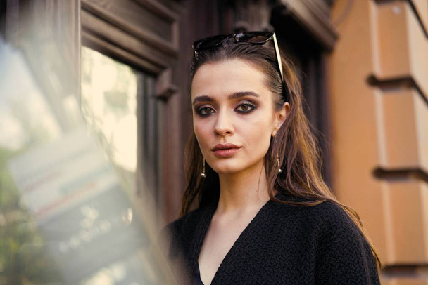 Gorgeous young brunette woman in black clothes posing on the street  - Foto, Bild
