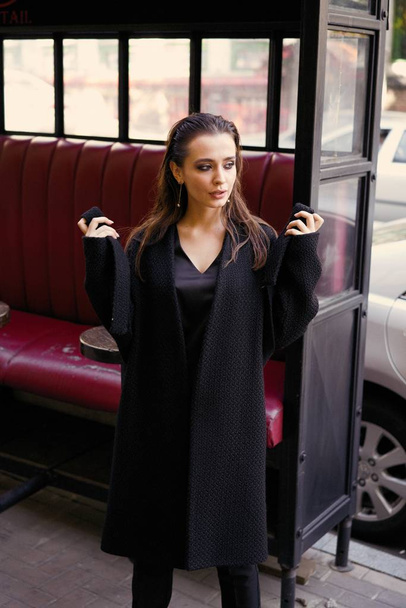 Gorgeous young brunette woman in black clothes posing - Foto, Imagem