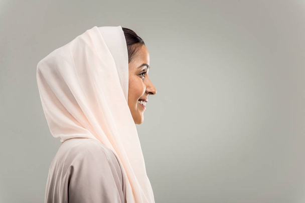 Portrait of arabic woman with abaya dress in a studio - Фото, изображение