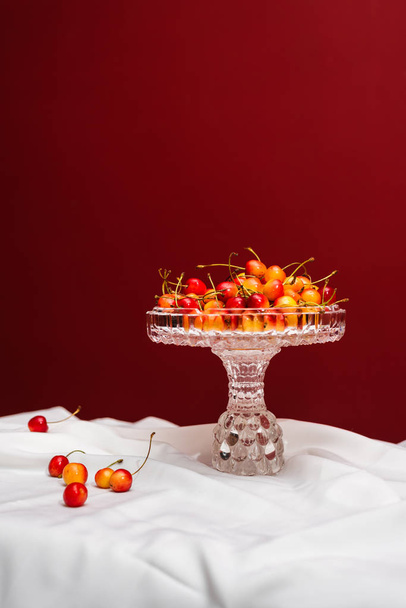 Delightful cherries on white and red background with copy space - Fotoğraf, Görsel