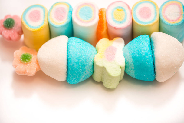 Background of twisted, colorful marshmallow, close up, macro. Sweets on a stick - Fotoğraf, Görsel