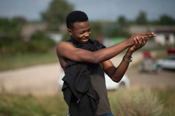 Confident cool African guy, imitating the firing of a finger - 写真・画像